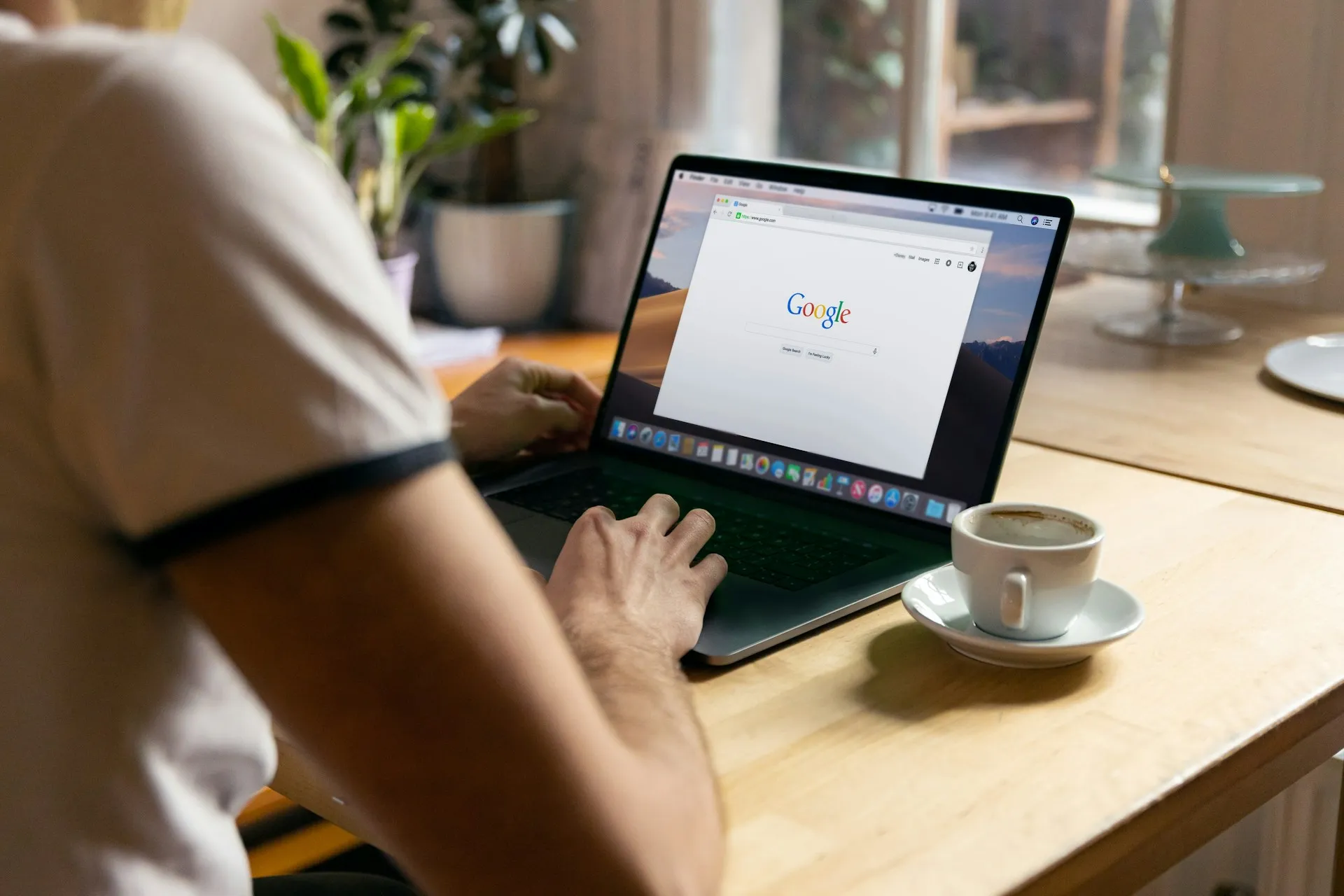 An image of a person using Google on a computer.